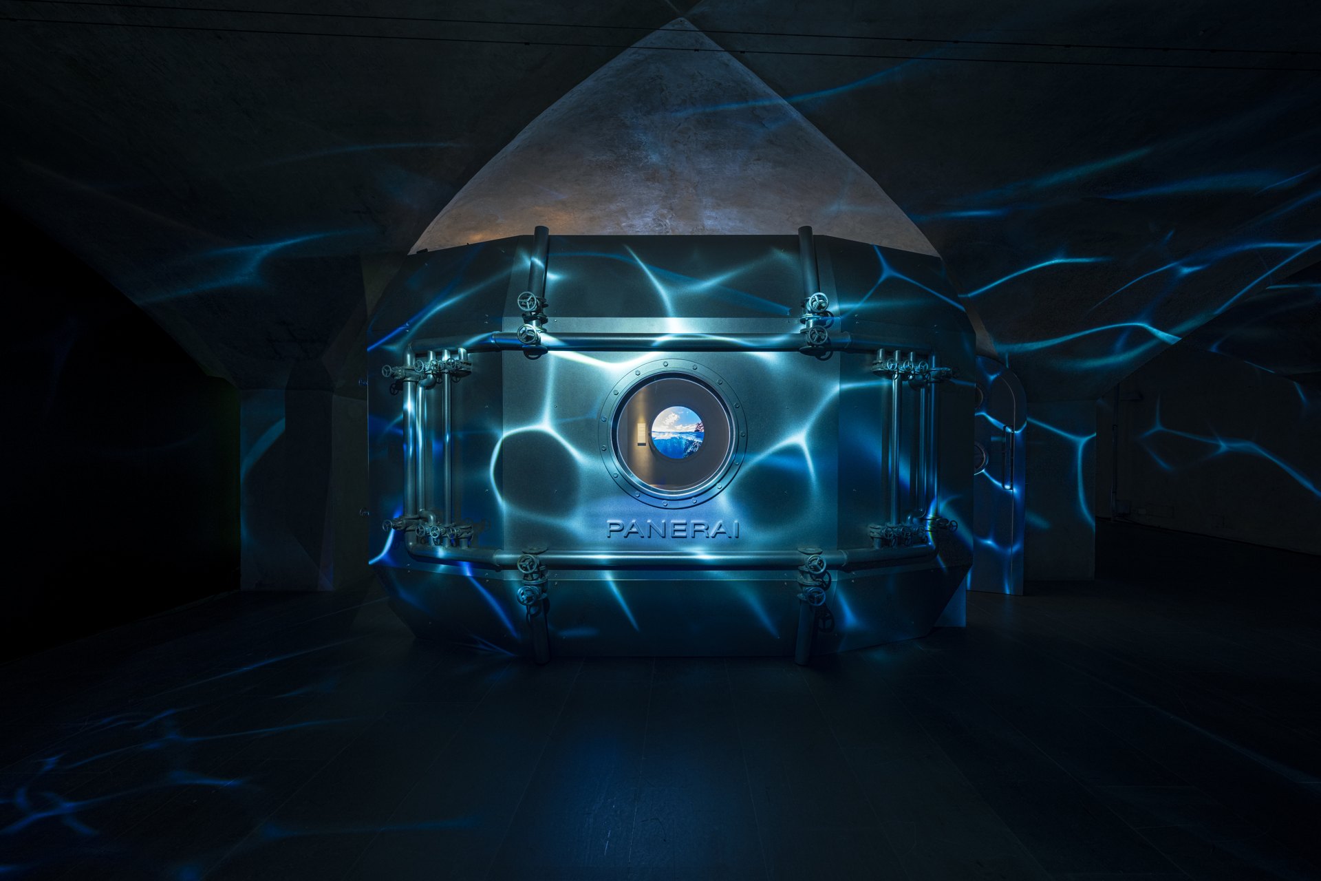 Underwater light projections surrounding the exhibition portholes
